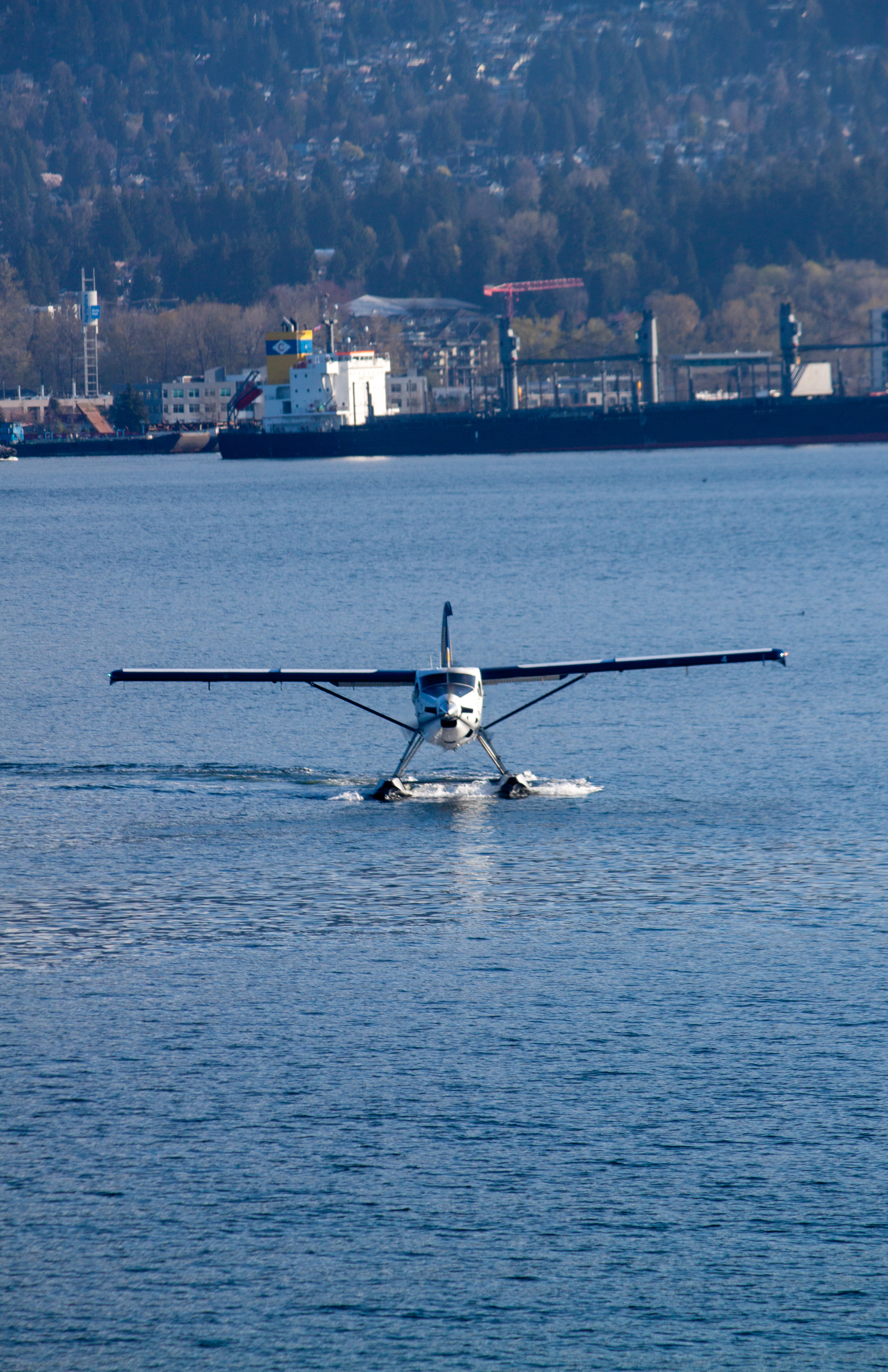 Floatplane approaching dock with downtown backdrop
